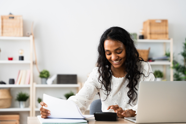 Small business owner using calculator.